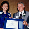 Co-founder of rhythmic gymnastics in Alberta, Helgi Leesment, receives a provincial award from Tourism Minister Don Sparrow in 1992.
