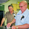 Allan Posti and August Liivam preparing a pioneer breakfast at Gilby Centennial celebrations in 2001.  