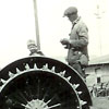 Gus married in 1924. He and one of his children, young Karl, are shown with their tractor. The lugs on the wheel were for traction in muddy fields when pulling combines, plows, seeders, discs and grain wagons.