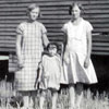 Alma Hebenik, Olga Mottus and young Dorothy Kulpas beside a cook car, 1929.A cook house was essential for a threshing crew. The cook houses were pulled out into the field to feed 20 or more workers.Mechanization of farming resulted in harvest crews being reduced to one or two hired men. The cook houses were often recycled as chicken coops or living quarters for hired men.