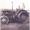 Ernie and Jim Kerbes operate a tractor on their family farm near Stettler, Alberta.